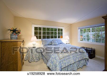 Stock Photo - Illuminated bedroom in residence. Fotosearch