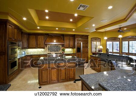 Illuminated kitchen in residence View Large Photo Image Stock Image - Illuminated kitchen in residence. Fotosearch