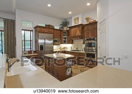 Illuminated kitchen in residence View Large Photo Image Stock Photo - Illuminated kitchen in residence. Fotosearch