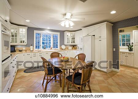 Stock Photograph - Illuminated kitchen in residence. Fotosearch