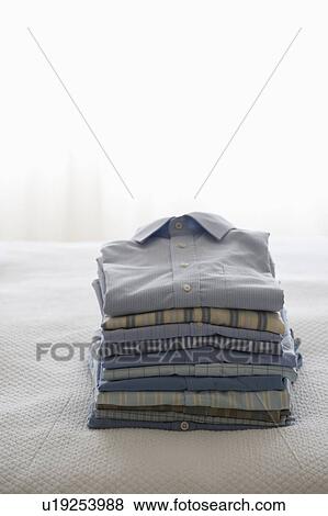 Ironed and folded shirts View Large Photo Image Stock Photo - Ironed and folded shirts. Fotosearch