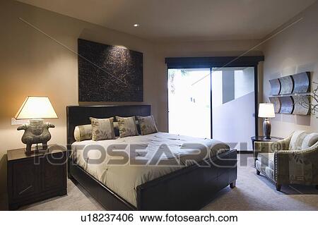 Lit bedroom of palm Springs home View Large Photo Image Stock Photograph - Lit bedroom of palm Springs home. Fotosearch