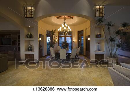 Stock Photograph - Lit circular dining room of Palm Springs home. Fotosearch