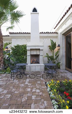 Stock Image - Lit stove in courtyard garden of Palm Springs home. Fotosearch