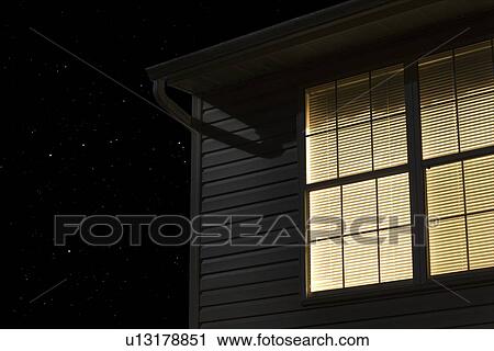 Stock Image - Lit window of building exterior. Fotosearch