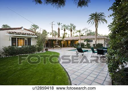 Stock Photo - Luxurious patio with swimming pool. Fotosearch