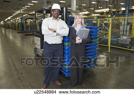 Man and woman working in newspaper factory View Large Photo Image Picture - Man and woman working in newspaper factory. Fotosearch