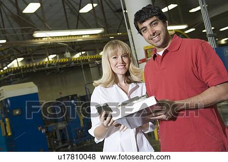 Stock Photo - Man and woman working in newspaper factory. Fotosearch