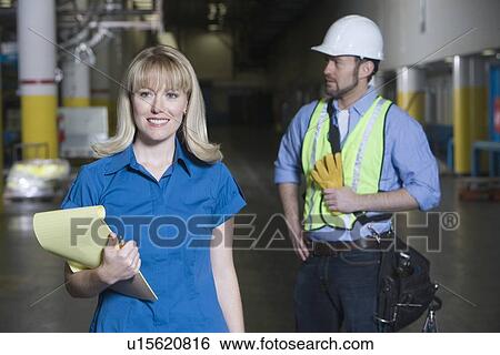 Stock Photograph - Man and woman working in newspaper factory. Fotosearch