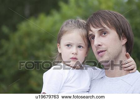 Man holds girl with her hand round his neck View Large Photo Image Stock Image - Man holds girl with her hand round his neck. Fotosearch