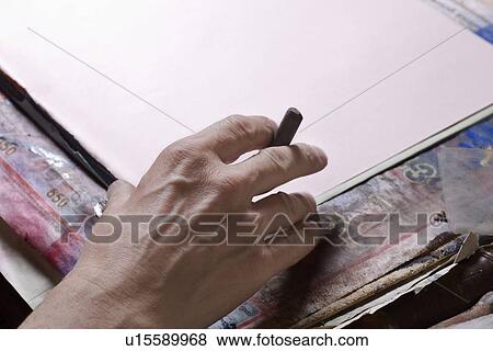 Man holds pastel preparing to draw View Large Photo Image Stock Photo - Man holds pastel preparing to draw. Fotosearch