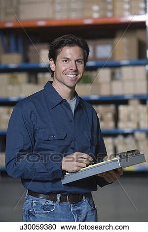 Man in distribution warehouse portrait View Large Photo Image Stock Image - Man in distribution warehouse portrait. Fotosearch