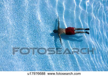 Stock Photo - Man in swimming pool view from above. Fotosearch