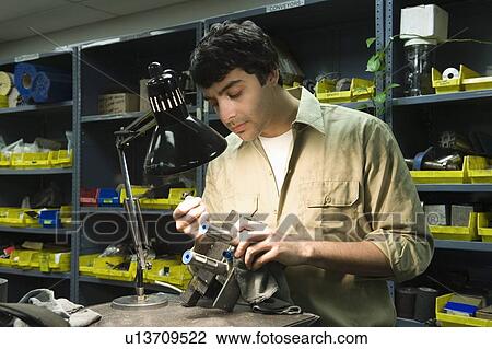 Stock Image - Man in workshop with tools. Fotosearch