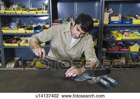 Man in workshop with tools View Large Photo Image Stock Image - Man in workshop with tools. Fotosearch