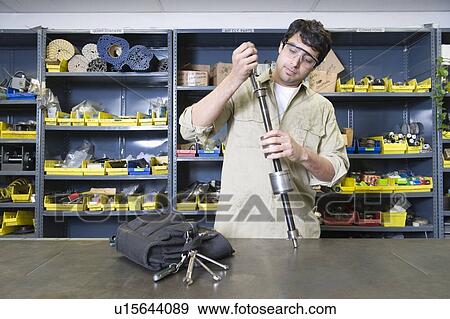 Stock Photo - Man in workshop with tools. Fotosearch