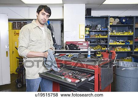 Stock Photo - Man in workshop with tools. Fotosearch