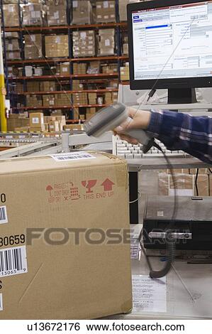 Man scanning bar code in distribution warehouse View Large Photo Image Stock Photograph - Man scanning bar code in distribution warehouse. Fotosearch