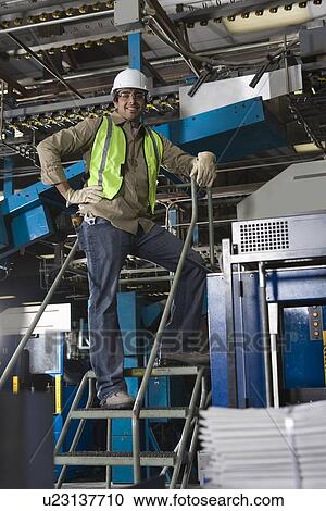 Man working in factory on steps View Large Photo Image Stock Image - Man working in factory on steps. Fotosearch