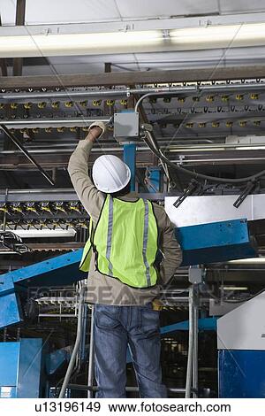 Man working in factory View Large Photo Image Stock Photo - Man working in factory. Fotosearch