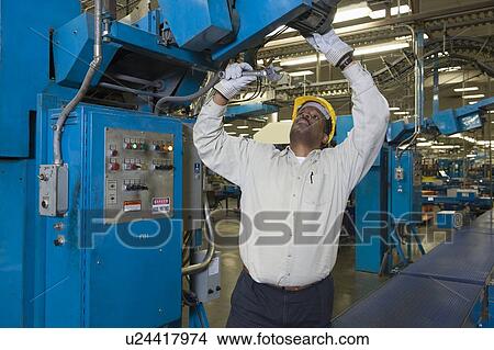 Picture - Man working in newspaper factory. Fotosearch