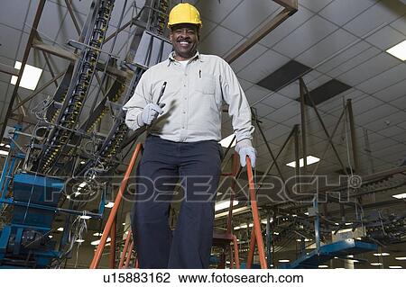 Stock Image - Man working in newspaper factory. Fotosearch