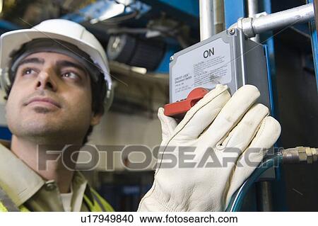 Stock Image - Man working in newspaper factory. Fotosearch