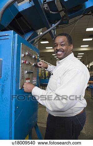 Stock Image - Man working in newspaper factory. Fotosearch