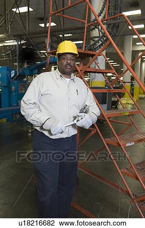 Stock Image - Man working in newspaper factory. Fotosearch