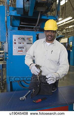 Stock Photo - Man working in newspaper factory. Fotosearch