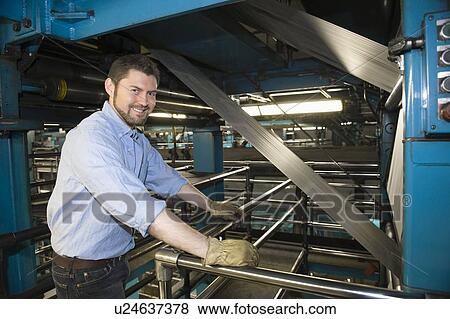 Man working in newspaper factory View Large Photo Image Stock Photo - Man working in newspaper factory. Fotosearch