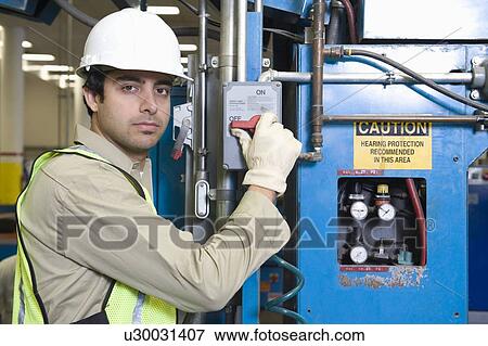 Stock Photo - Man working in newspaper factory. Fotosearch