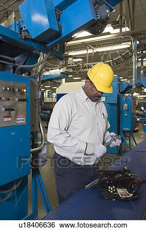 Man working in newspaper factory View Large Photo Image Stock Photograph - Man working in newspaper factory. Fotosearch