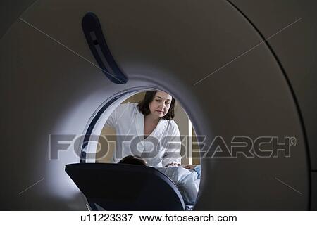Stock Photo - Medical exam in CAT scan machine. Fotosearch