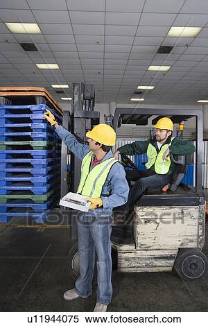 Stock Photography - Men working in factory. Fotosearch
