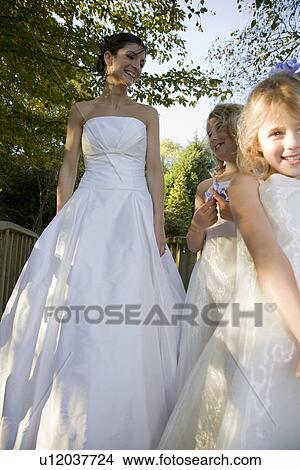 Mid-adult bride with two girl bridesmaids View Large Photo Image Picture - Mid-adult bride with two girl bridesmaids. Fotosearch