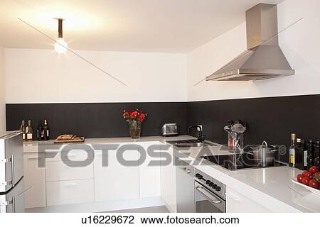 Stock Image - Minimalist kitchen with bare light. Fotosearch