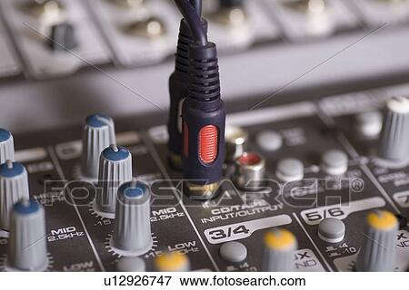 Stock Photo - Mixing console with wires plugged in. Fotosearch