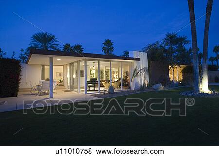 Modern house exterior illuminated at night View Large Photo Image Stock Photo - Modern house exterior illuminated at night. Fotosearch