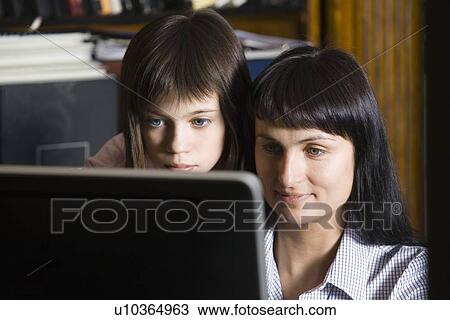 Mother and daughter looking at computer screen View Large Photo Image Stock Image - Mother and daughter looking at computer screen. Fotosearch
