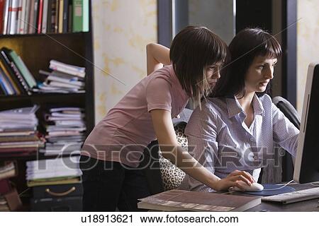 Mother and daughter looking at computer screen View Large Photo Image Stock Image - Mother and daughter looking at computer screen. Fotosearch