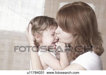 Mother comforts crying child View Large Photo Image Stock Image - Mother comforts crying child. Fotosearch