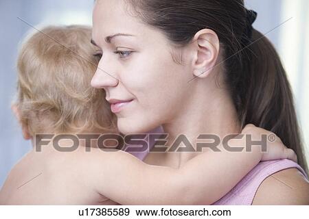 Mother holds blonde toddler View Large Photo Image Stock Photo - Mother holds blonde toddler. Fotosearch