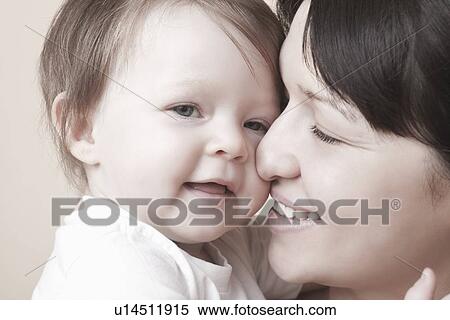 Stock Photography - Mother squashes her nose against toddlers face. Fotosearch