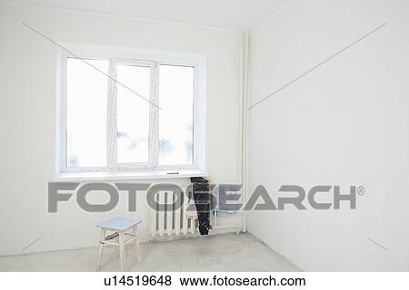 Old clothes on radiator under window of new apartment View Large Photo Image Stock Photo - Old clothes on radiator under window of new apartment. Fotosearch