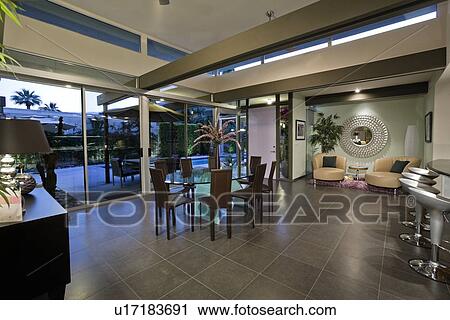 Stock Image - Open plan home interior with areas designated for dining and relaxing. Fotosearch