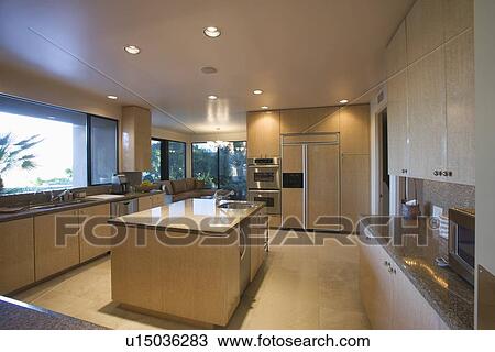 Stock Image - Open plan kitchen in neutral colours Palm Springs. Fotosearch