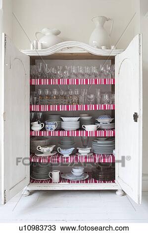 Open storage cupboard showing display of homeware View Large Photo Image Stock Image - Open storage cupboard showing display of homeware. Fotosearch