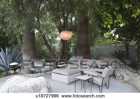Stock Photograph - Outdoor garden furniture in Palm Springs home. Fotosearch