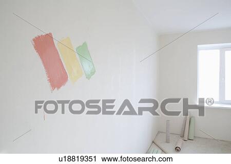 Stock Image - Paint samples on wall of new apartment. Fotosearch